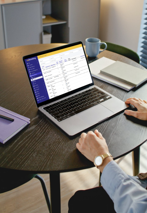 Two operators reviewing the cqbooking dashboard on a laptop